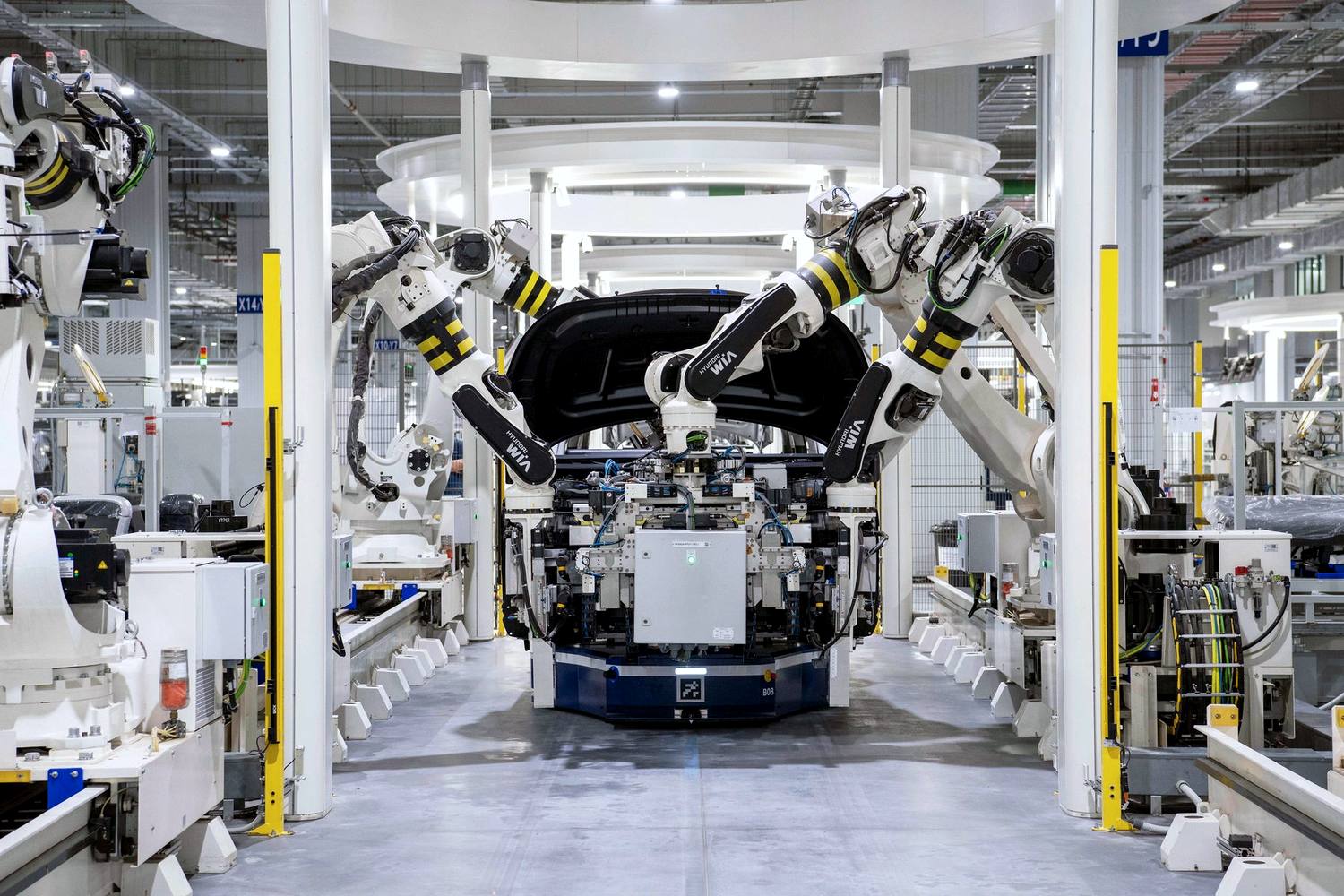 Industrial robots on an automotive body assembly line